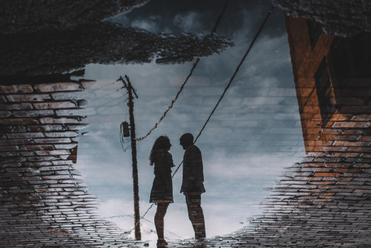water puddle reflection of engaged couple