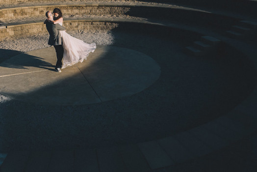 groom swinging his bride
