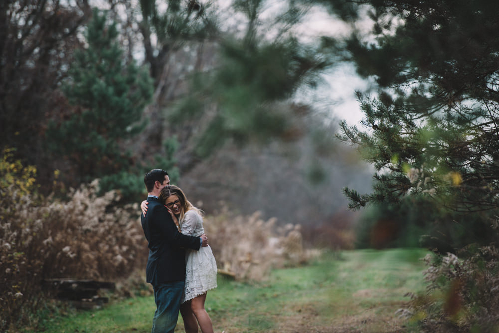 columbus engaged couple hugging tightly in nature