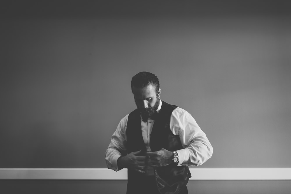 Groom getting dressed at Wedgewood Country Club wedding photography in Columbus