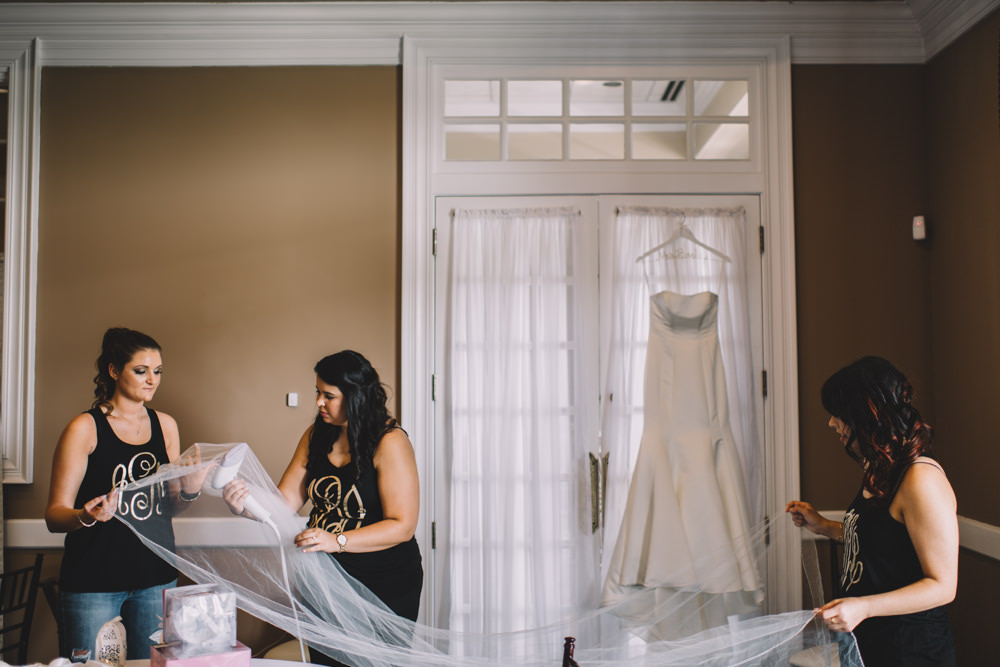 bridesmaid steaming a wedding veil