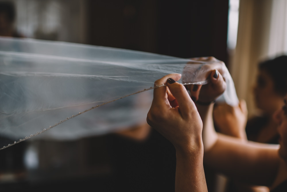 brides hands holding her veil