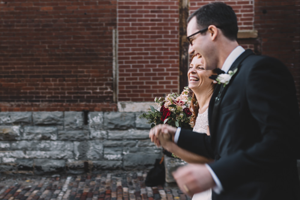 bride and groom recessional laughing together
