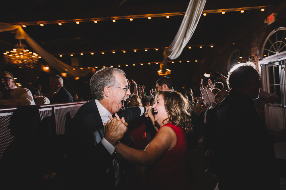 brides dad laughing hard during a dance