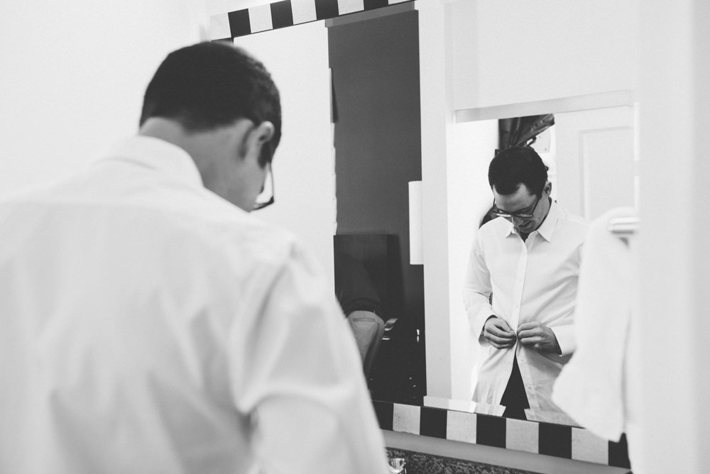 groom getting dressed in columbus ohio wedding