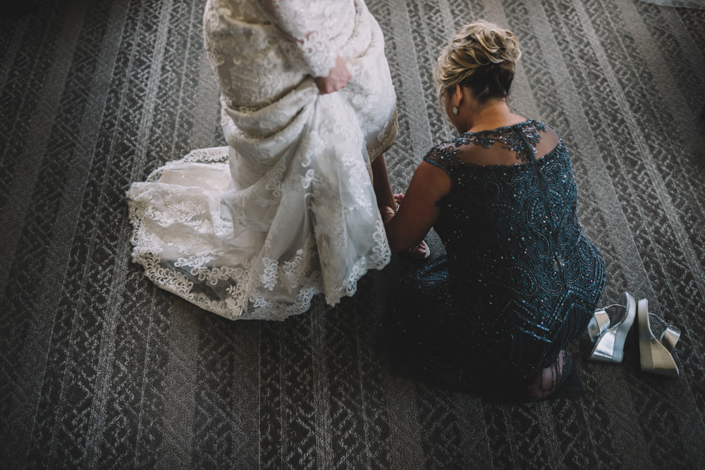 bride's mom putting her shoes on for her wedding in columbus, ohio